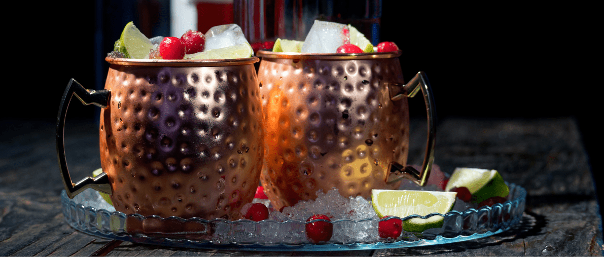 Copper mugs with ice and fruit garnish